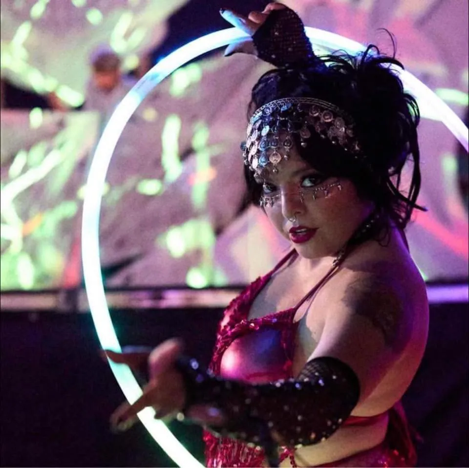 A costumed LED hoop dancer